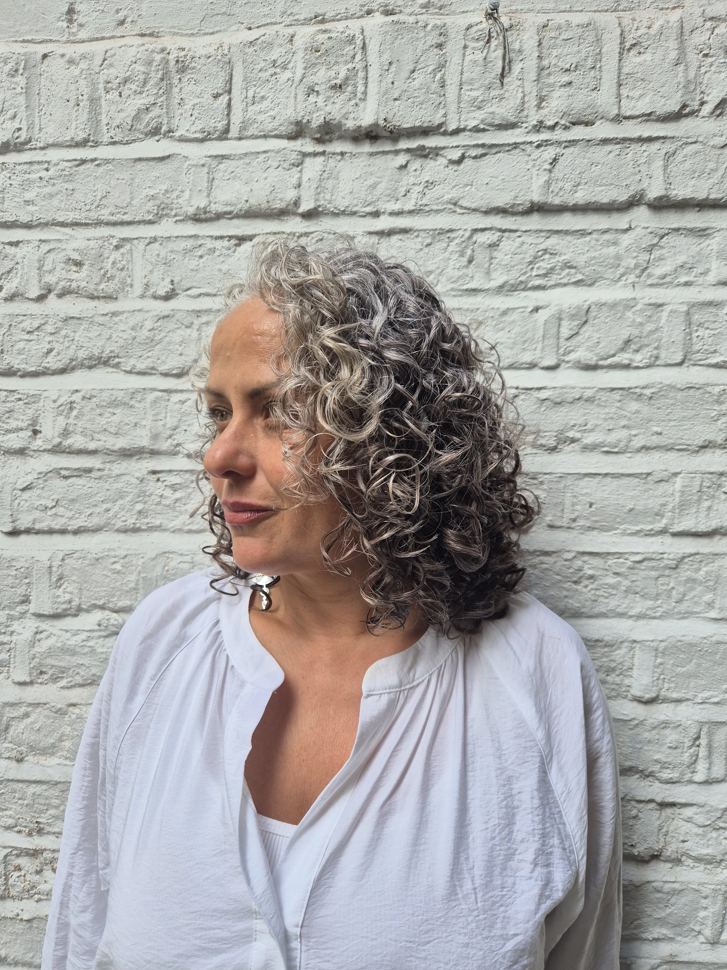 Short naturally grey curly hair