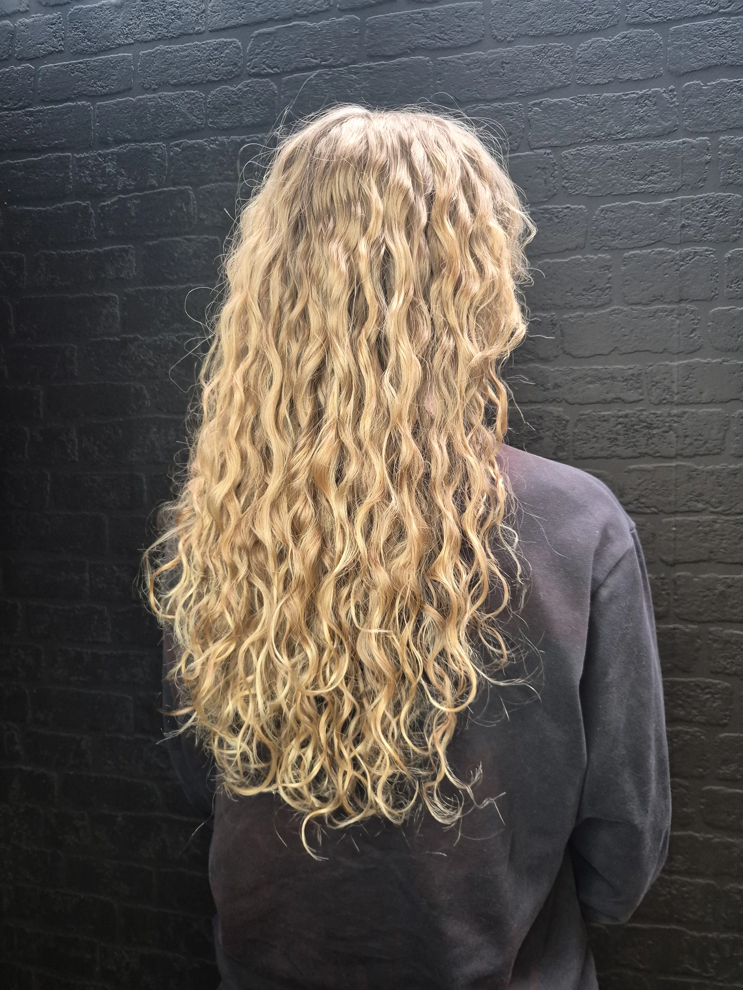 Long blonde textured hair with soft natural waves