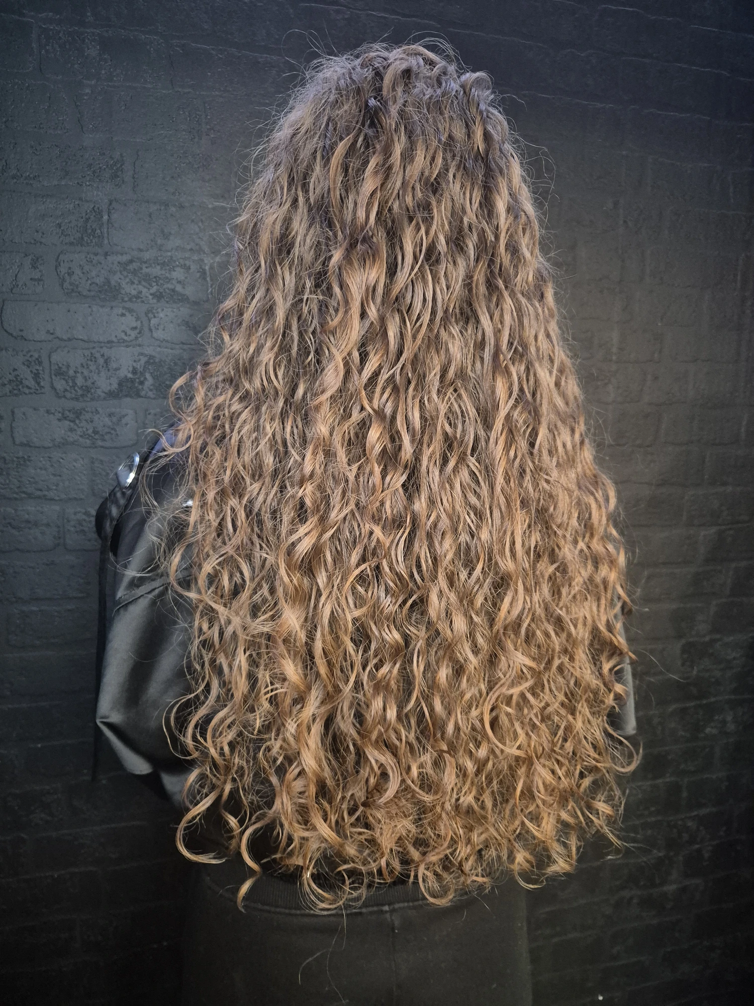 Long copper curly hair photographed from behind