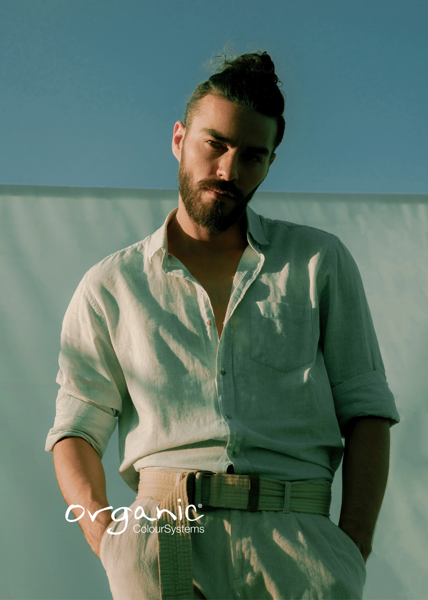 Brown men's hair styled in a top knot for Organic Colour Systems