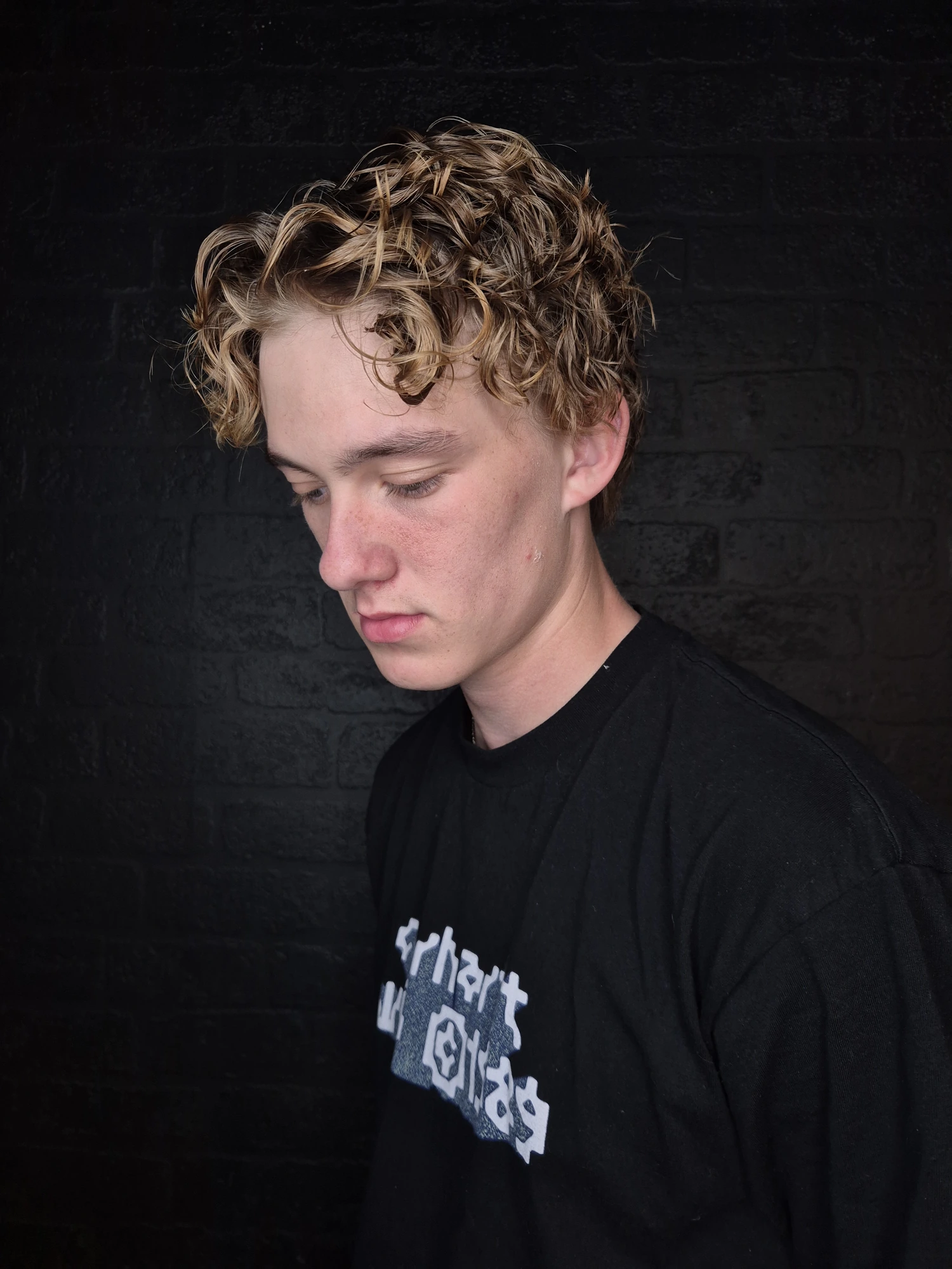 Men's short blonde curly hairstyle created at Oliver Stephens in Soho