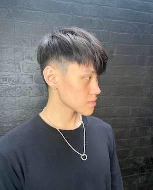 male model with hair shaved at sides, long fringe