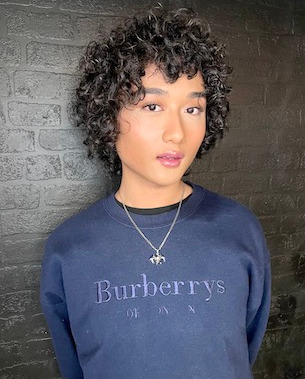 model with curly hair, mid-length