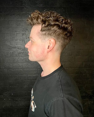 male model with hair shaved at sides, long on top