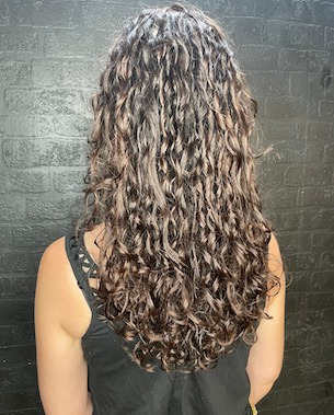 back view of model with long, curly hair